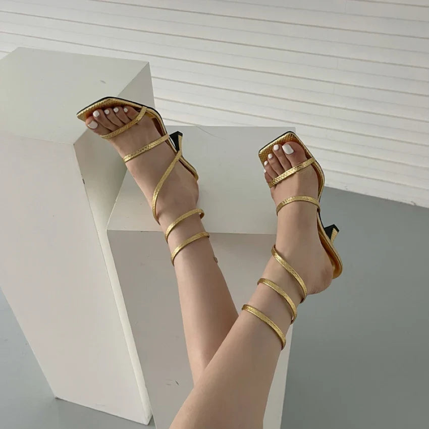 Luxurious women's sandals with heel and gold straps