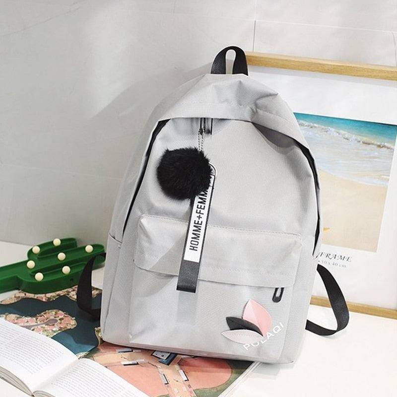 Fashionable backpack with decorative key ring and patch