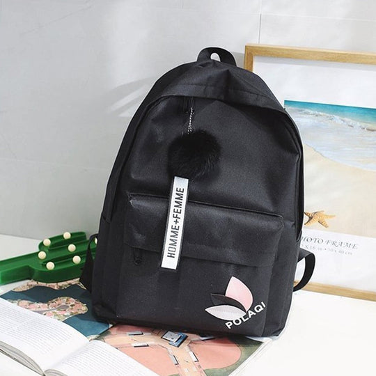 Fashionable backpack with decorative key ring and patch