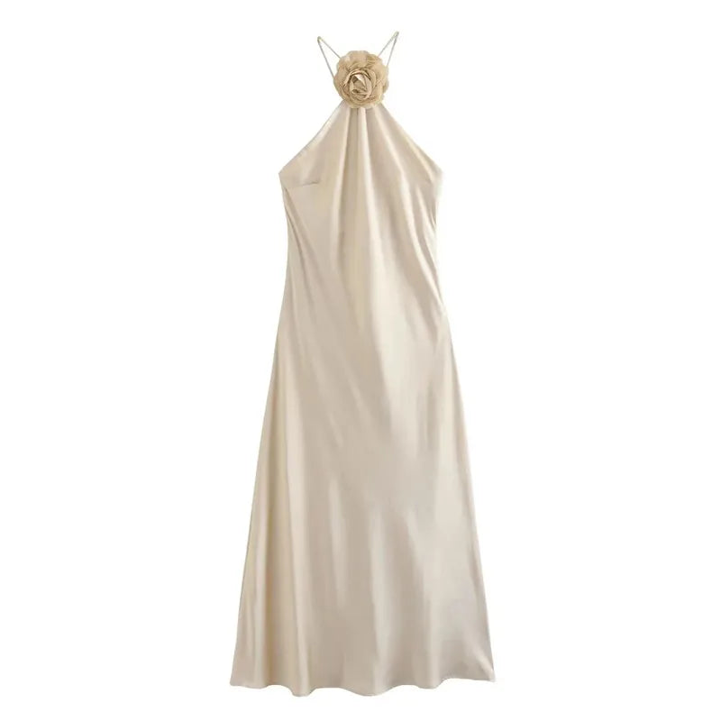 Satin midi dress with a flower on the neckline and thin straps