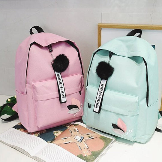Fashionable backpack with decorative key ring and patch