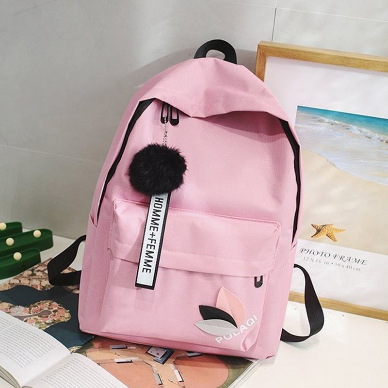 Fashionable backpack with decorative key ring and patch