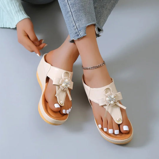 Women's sandals with low heel and metal decorations