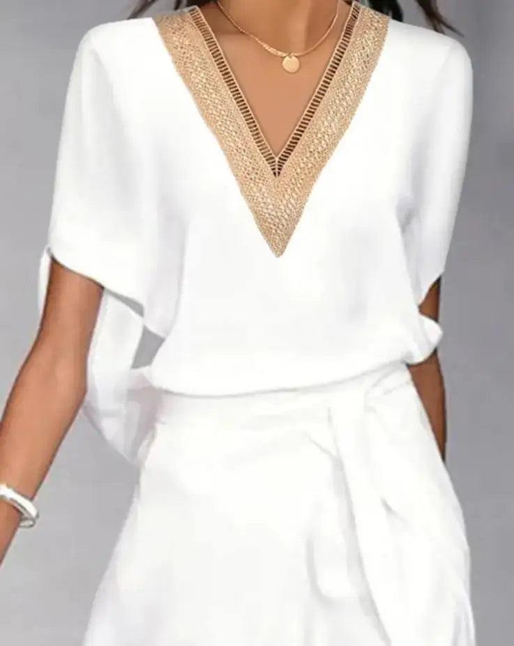 Floating dress with a wrap skirt and decorated neckline