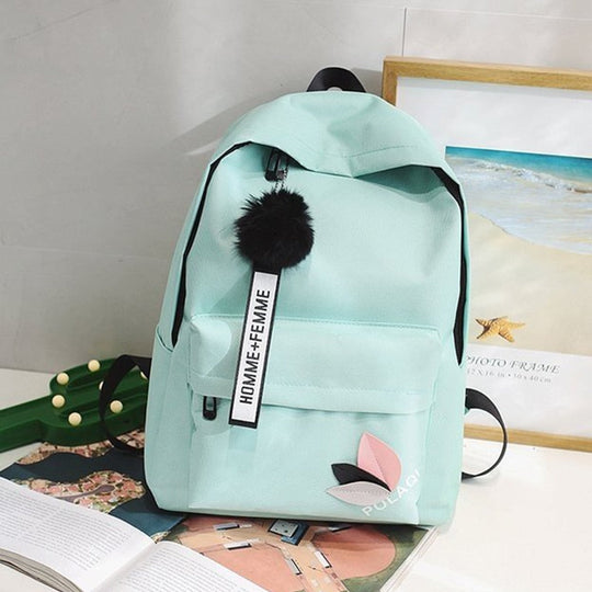 Fashionable backpack with decorative key ring and patch