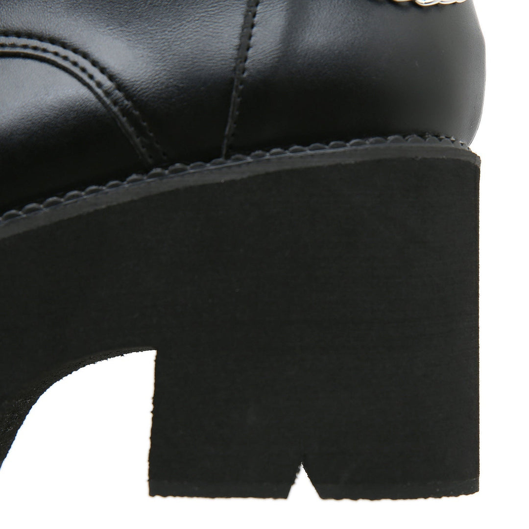Black Martens-style high-heeled boots